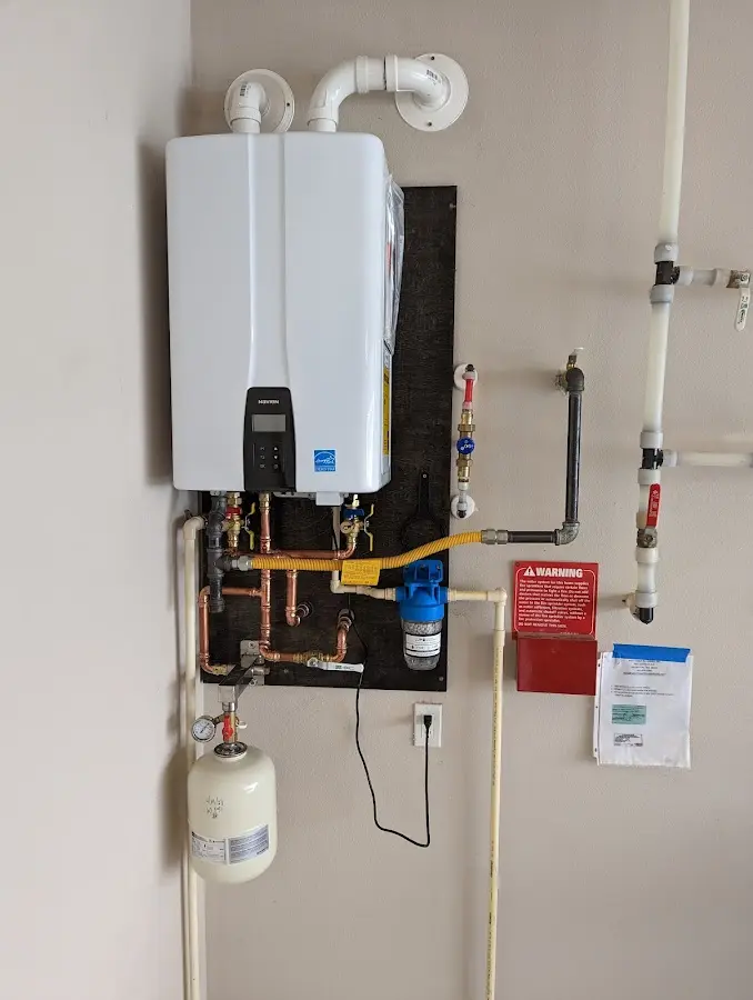 Professional plumber installing copper piping in a McGregor home